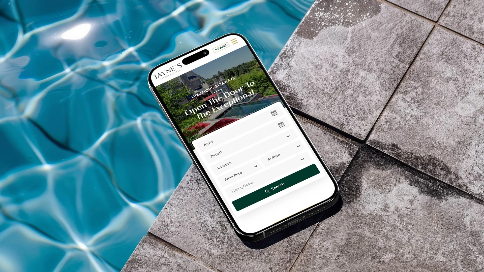 Jayne's Luxury Rentals mobile website on a phone by a swimming pool
